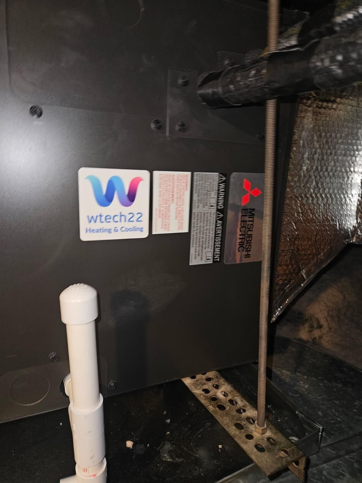 wtech22 Heating and Cooling label on new Mitsubishi ducted air handler installed in Cos Cob