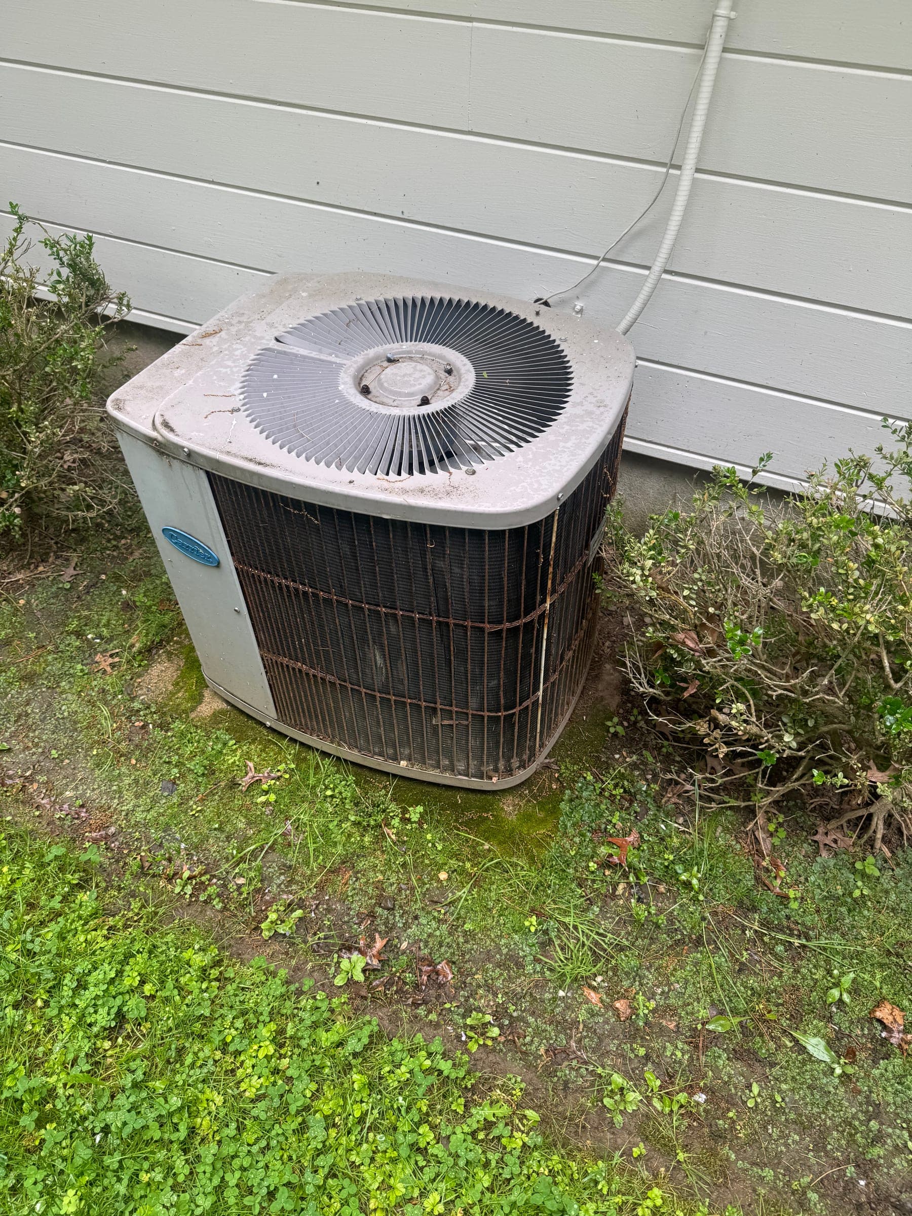 Old outdoor AC condenser before a Cos Cob Connecticut Mitsubishi heat pump replacement