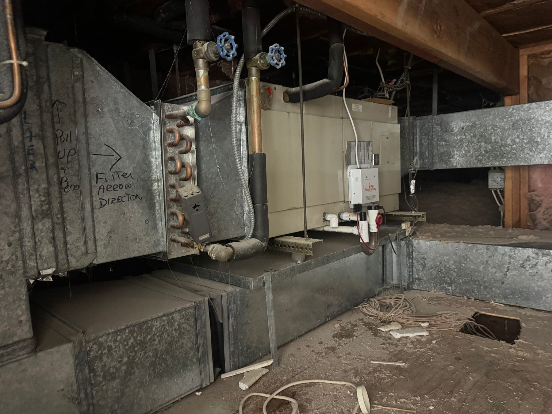 Old attic air handler and ductwork before a Cos Cob Connecticut heat pump installation