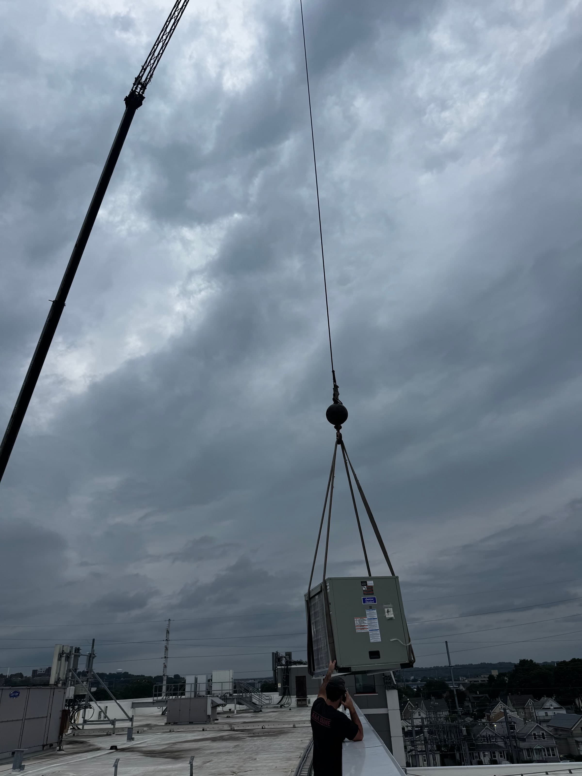 Commercial heat pump equipment being lifted by crane for a Connecticut installation