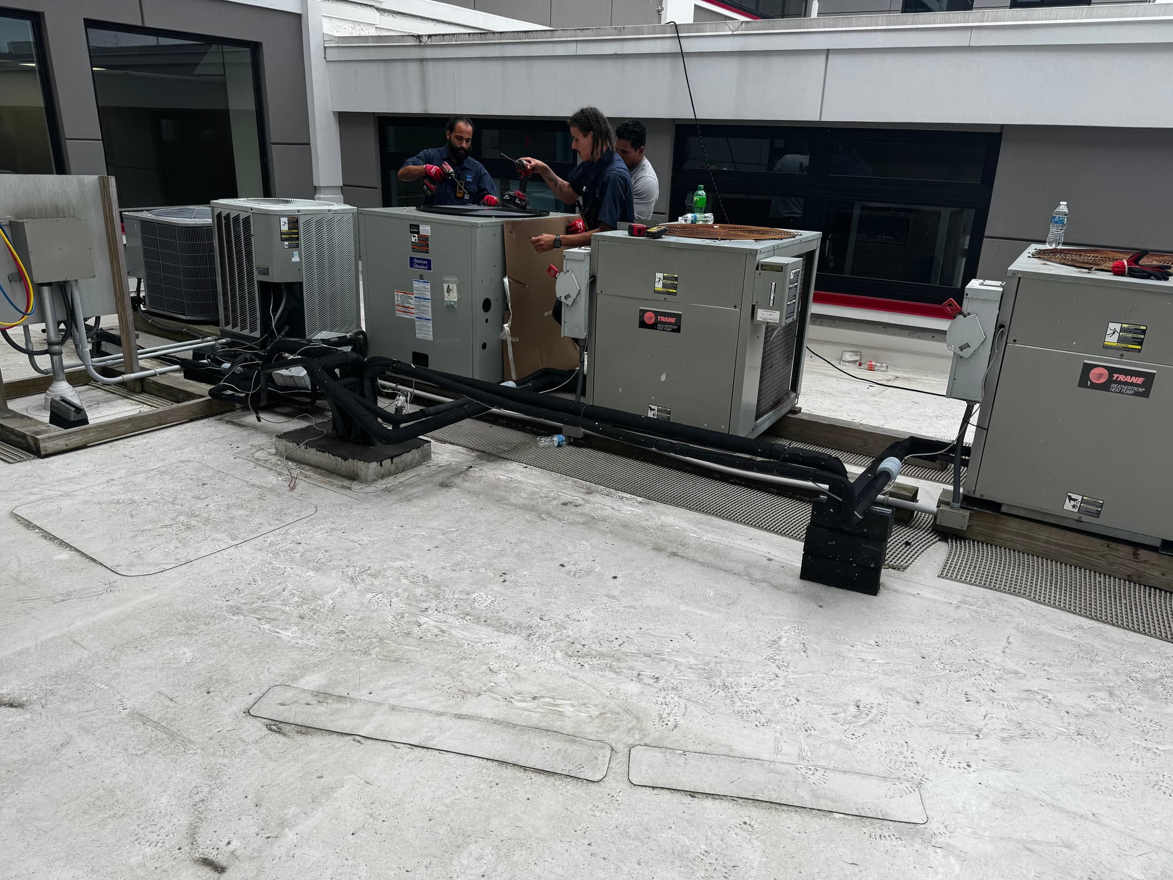 wtech22 Heating and Cooling team installing a commercial heat pump system in Connecticut