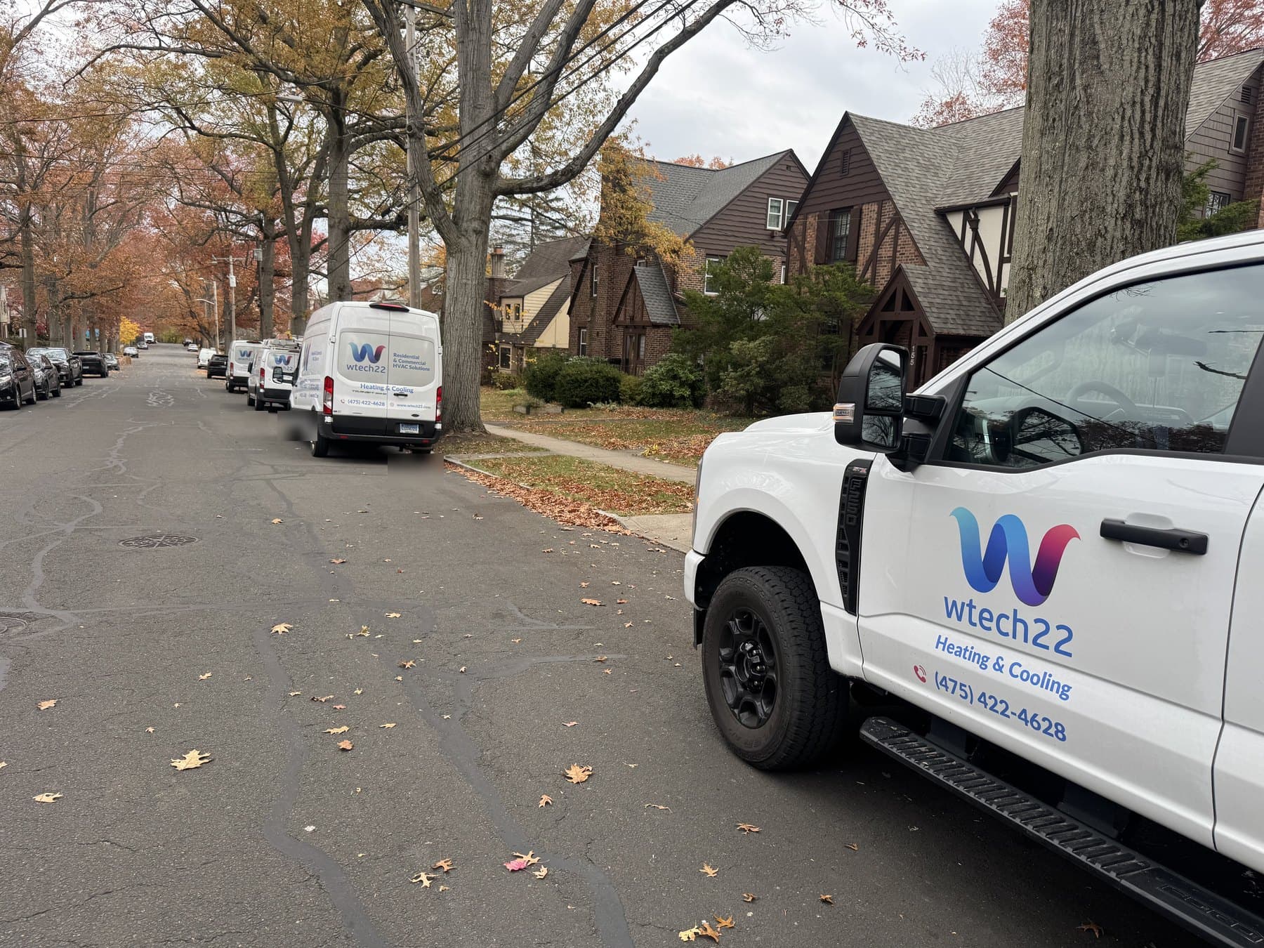 wtech22 Heating and Cooling service vehicles on a Connecticut neighborhood street for site visit planning