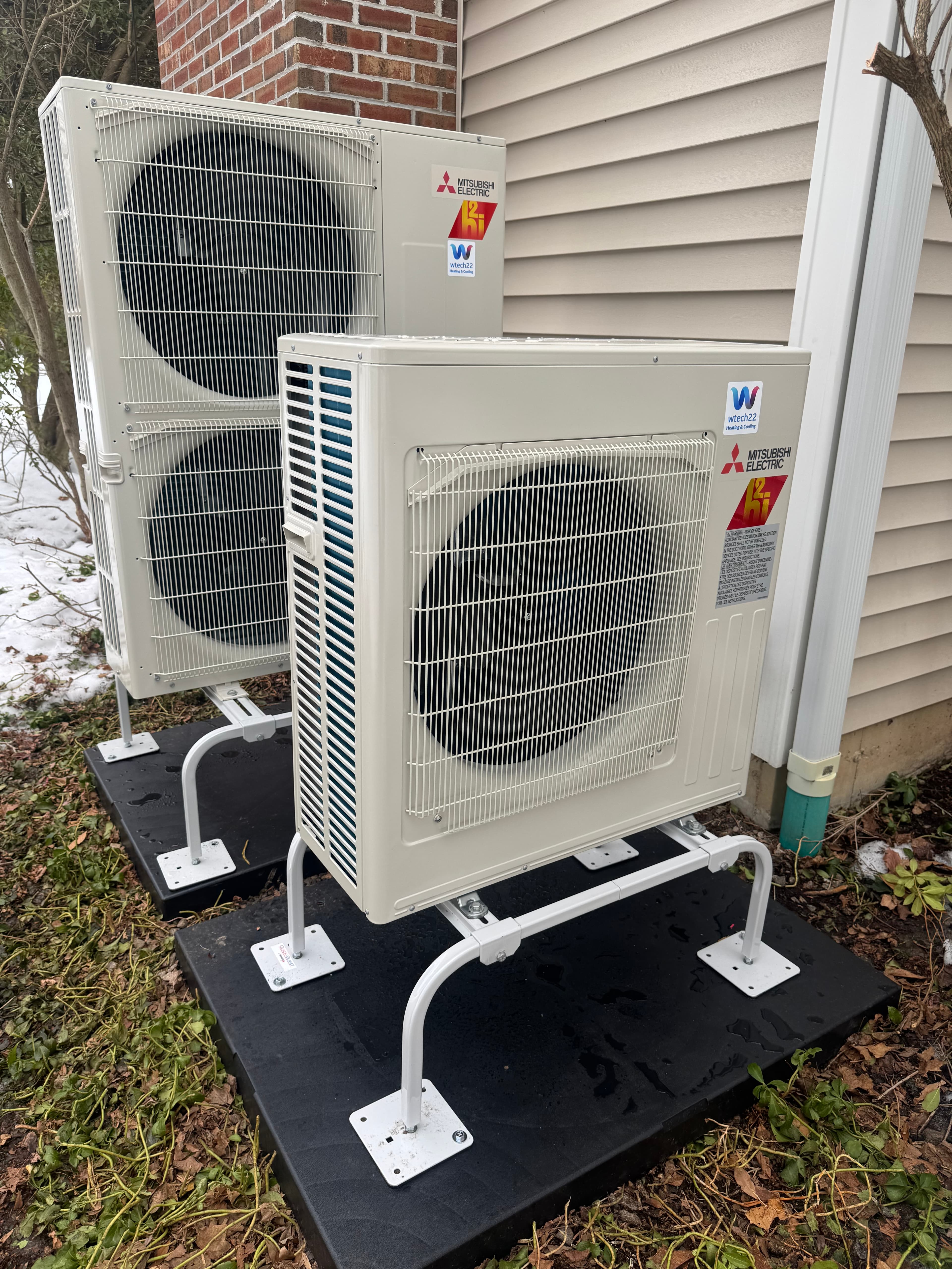 Rebate-eligible Mitsubishi cold-climate heat pump installation in Connecticut with elevated outdoor units